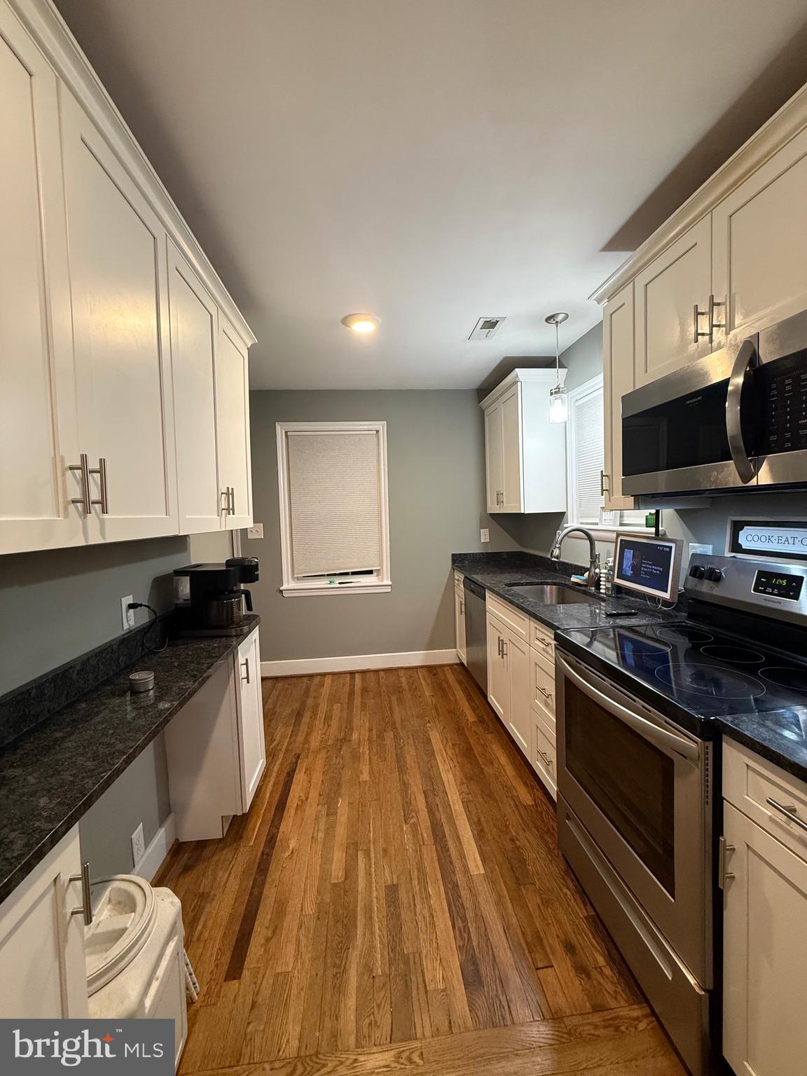 328 Bryan Place Hagerstown, MD 21740 - Photo 5 of 24 a large kitchen with stainless steel appliances granite countertop a stove a sink and a microwave