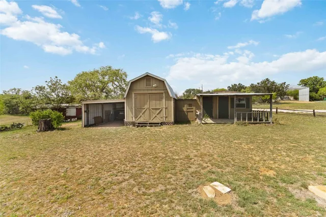 a view of a house with a backyard