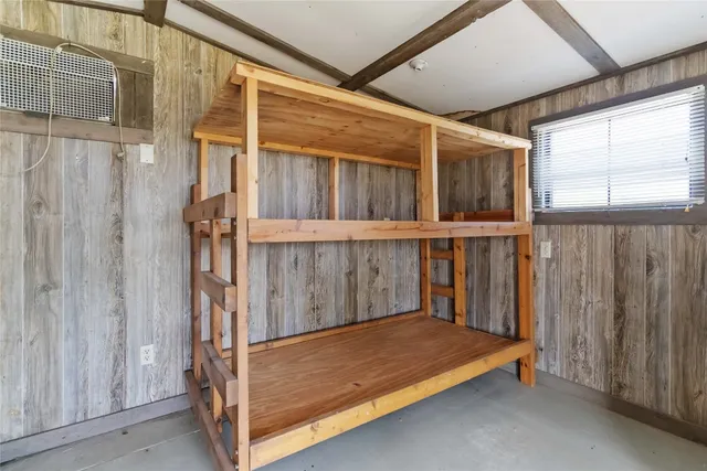 a view of a porch with wooden floor and a window