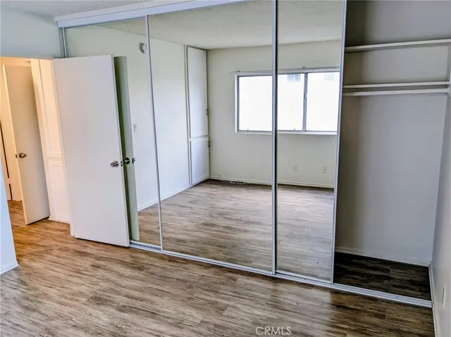 a view of a room with wooden floor and window