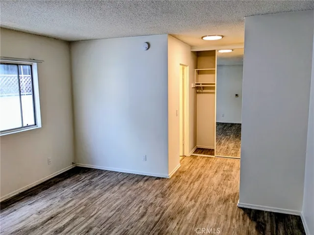 an empty room with wooden floor and a window
