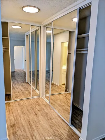 a view of a room with wooden floor and glass door
