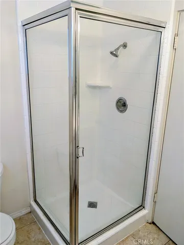 a bathroom with a glass shower door
