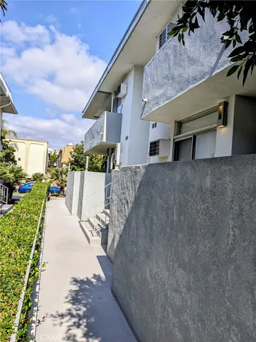 a view of a white house with a yard