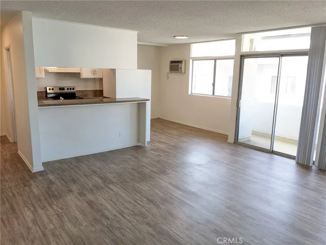 a kitchen with hard wood floors and white appliances