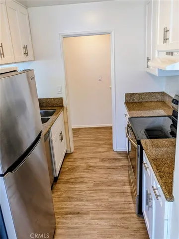 a kitchen with a stove and a refrigerator