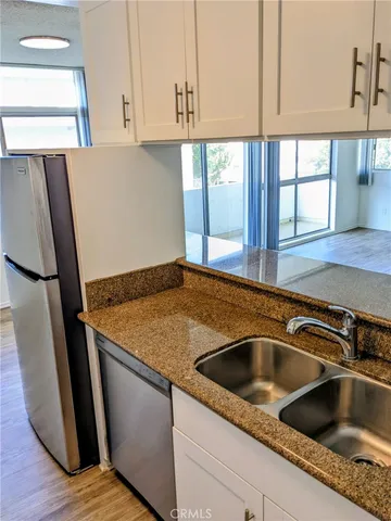 a kitchen with sink and a window