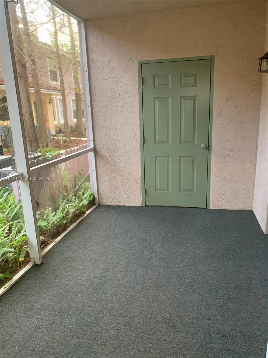 6572 West Sample Road, Unit 6572 Coral Springs, FL 33067 - Photo 16 of 17 an empty room with windows