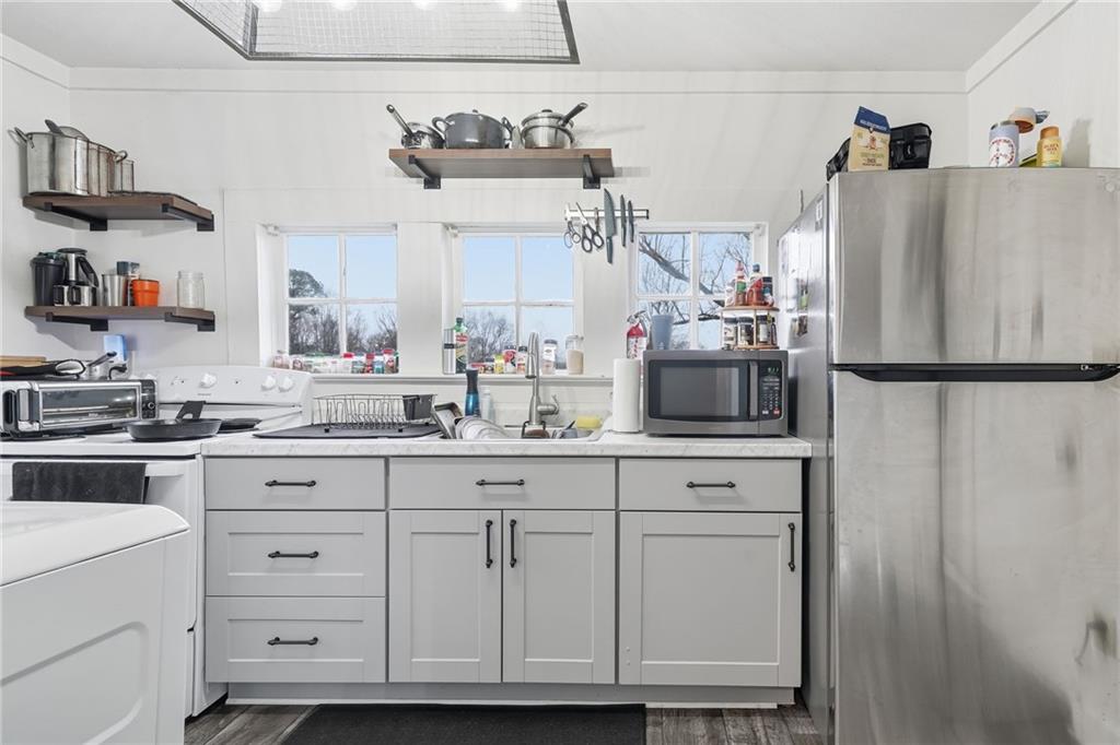 508 Old Canton Road Ball Ground, GA 30107 - Photo 17 of 28 a kitchen with cabinets stainless steel appliances and wooden floor