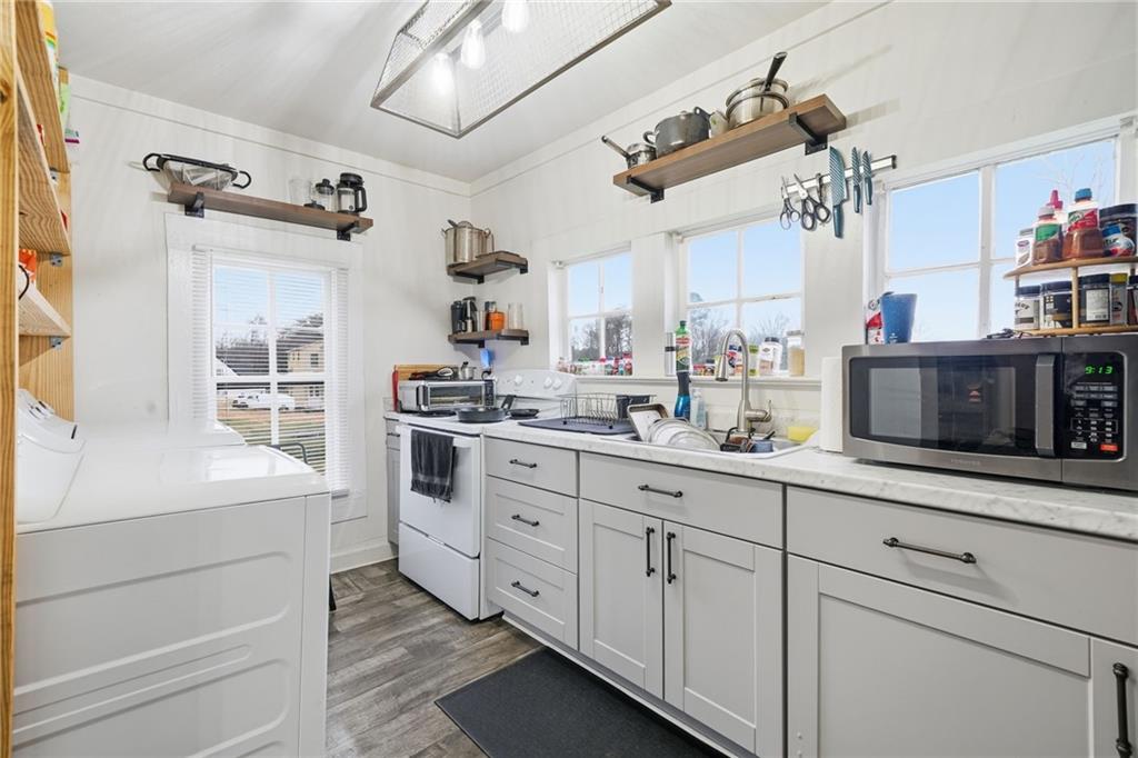 508 Old Canton Road Ball Ground, GA 30107 - Photo 19 of 28 a kitchen with cabinets stainless steel appliances and a counter space