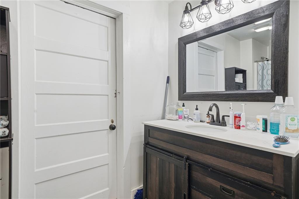 508 Old Canton Road Ball Ground, GA 30107 - Photo 22 of 28 a bathroom with a sink a vanity and a mirror