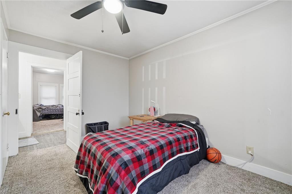 508 Old Canton Road Ball Ground, GA 30107 - Photo 27 of 28 a bedroom with a bed and a chandelier