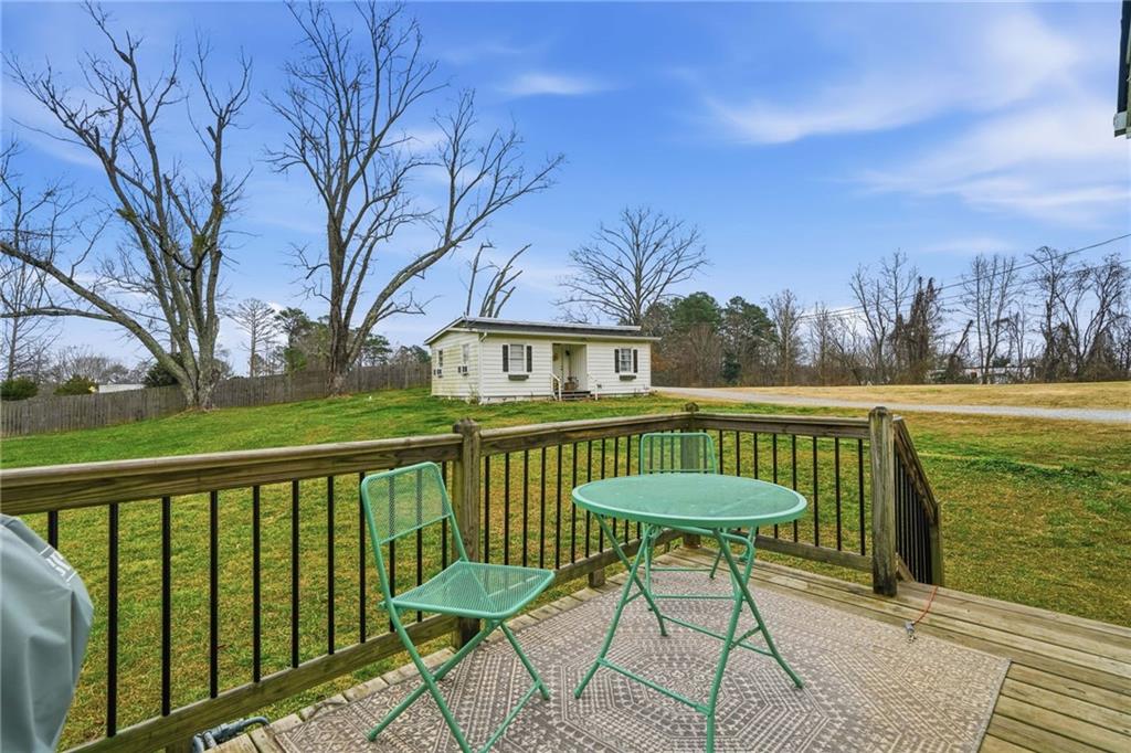 508 Old Canton Road Ball Ground, GA 30107 - Photo 8 of 28 a view of a chairs and table on the deck
