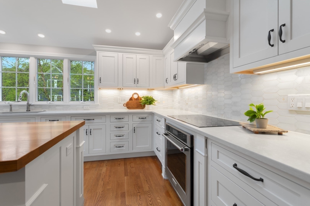 32 Sturges Road Reading, MA 01867 - Photo 11 of 39 a kitchen with granite countertop a sink stainless steel appliances and cabinets