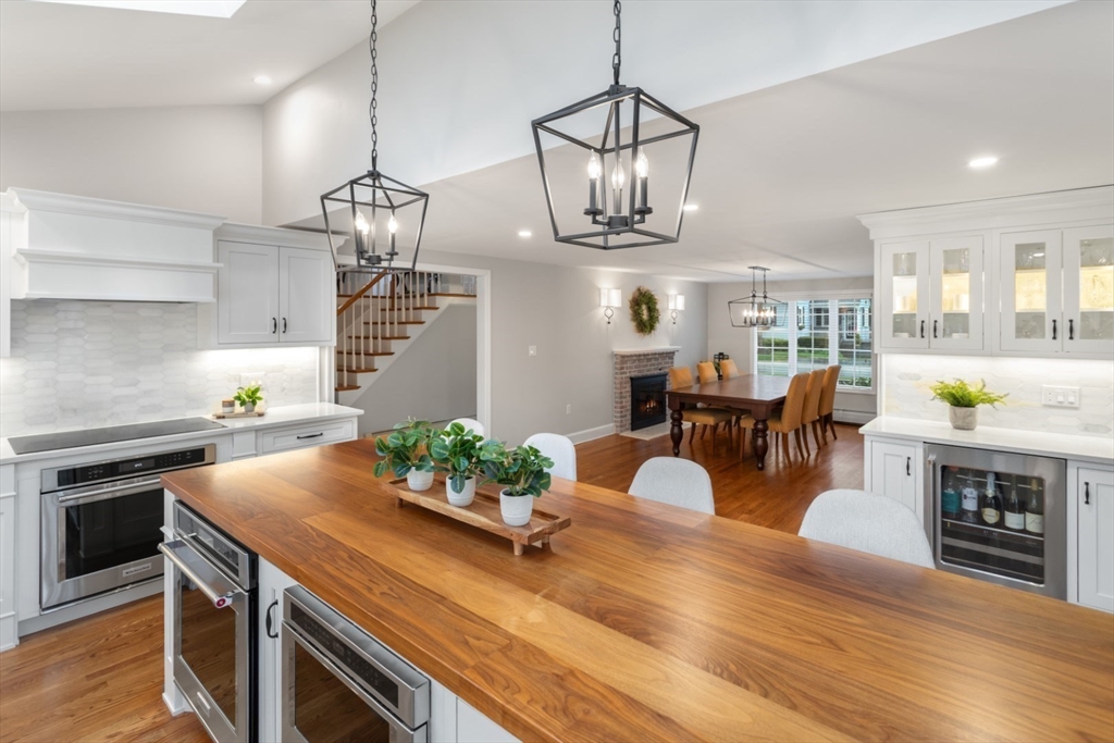 32 Sturges Road Reading, MA 01867 - Photo 13 of 39 a living room with kitchen island furniture and a chandelier