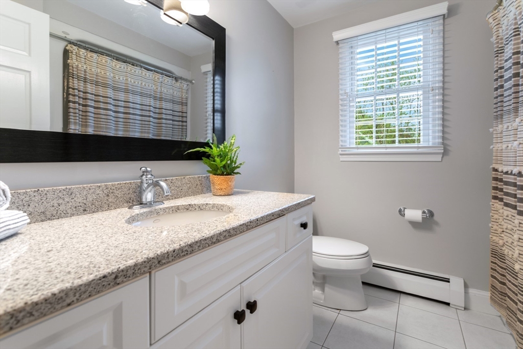 32 Sturges Road Reading, MA 01867 - Photo 22 of 39 a bathroom with a granite countertop sink toilet and a mirror