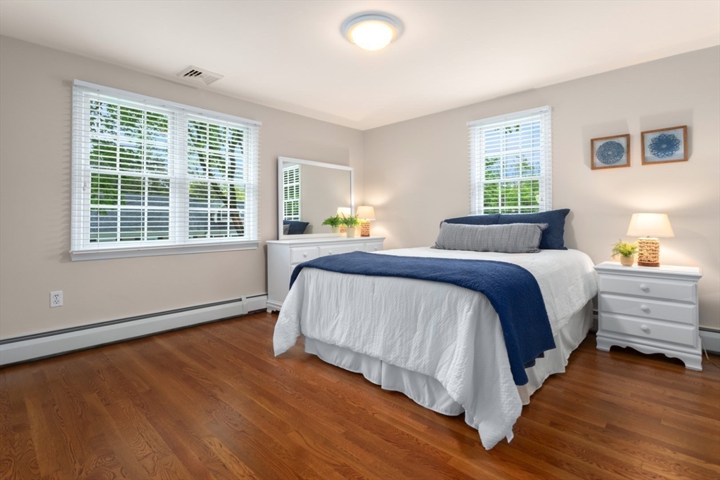 32 Sturges Road Reading, MA 01867 - Photo 23 of 39 a spacious bedroom with a bed and a window