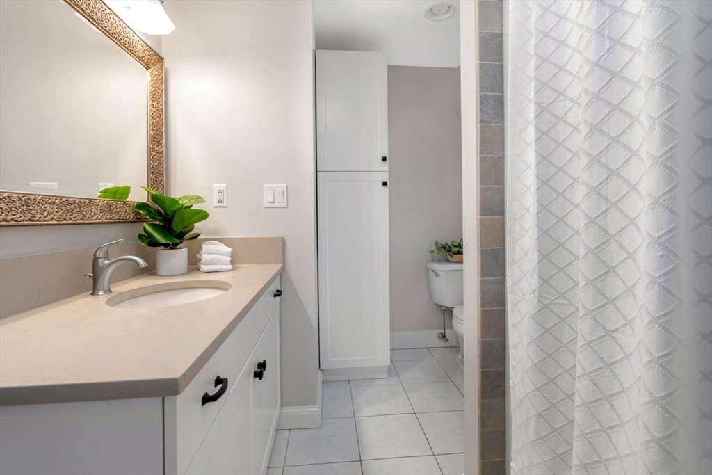 32 Sturges Road Reading, MA 01867 - Photo 25 of 39 a bathroom with a granite countertop sink a toilet and shower