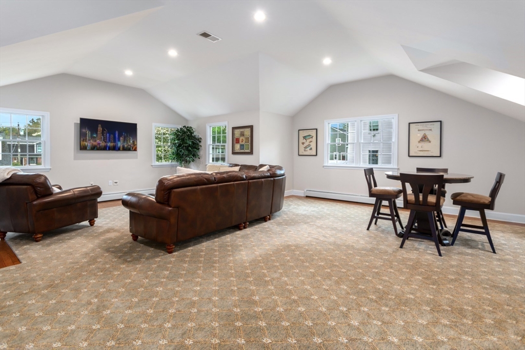 32 Sturges Road Reading, MA 01867 - Photo 29 of 39 a living room with furniture and a flat screen tv