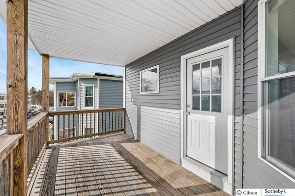 a view of a house with wooden deck