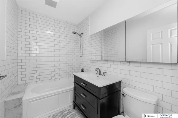 a bathroom with a sink a toilet and bathtub