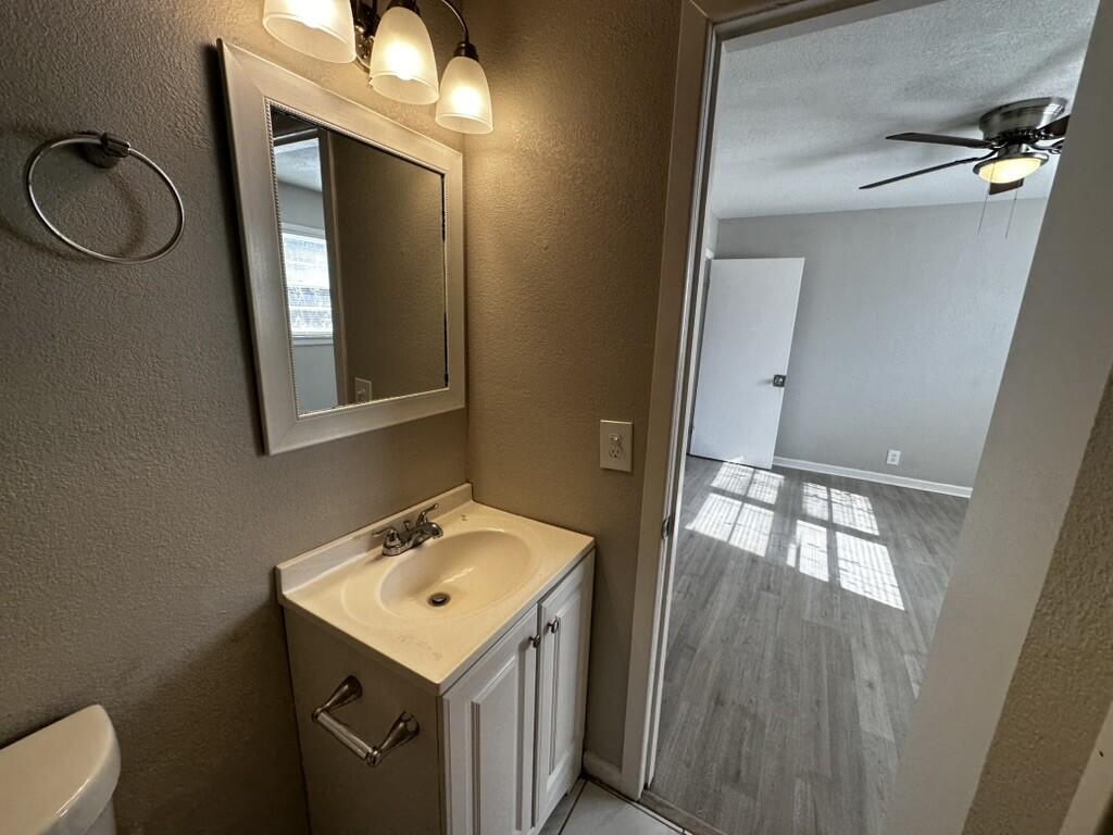 1602 39th Street Lubbock, TX 79412 - Photo 13 of 14 a bathroom with a sink and a mirror