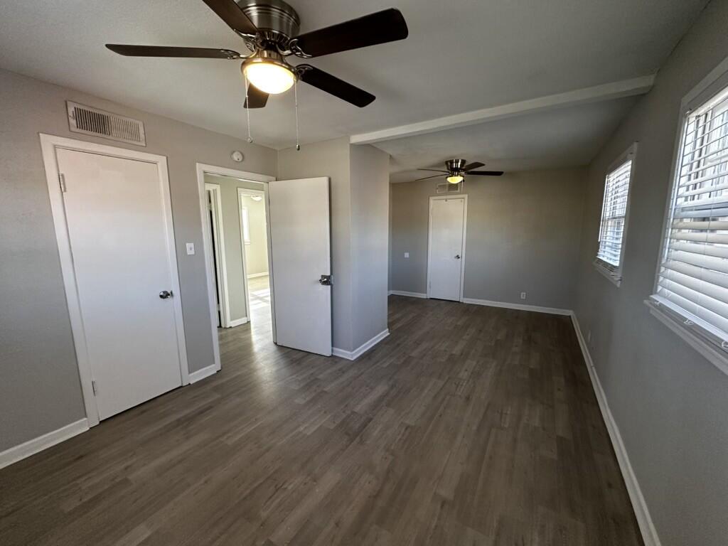 1602 39th Street Lubbock, TX 79412 - Photo 8 of 14 wooden floor in an empty room with a window