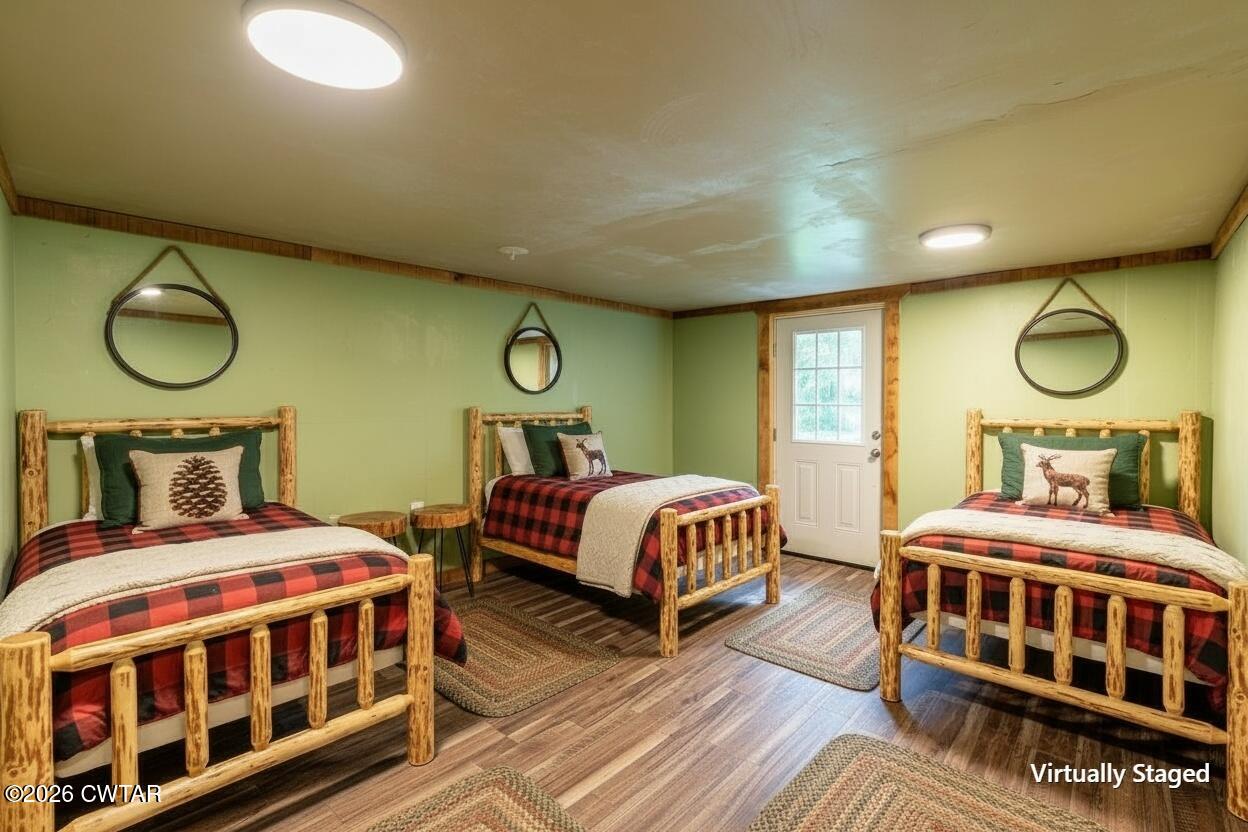 3454 Treece Road Hornbeak, TN 38232 - Photo 18 of 25 a bedroom with a bed and wooden floor
