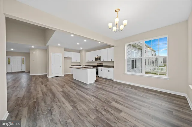 a kitchen with stainless steel appliances granite countertop a stove and a sink