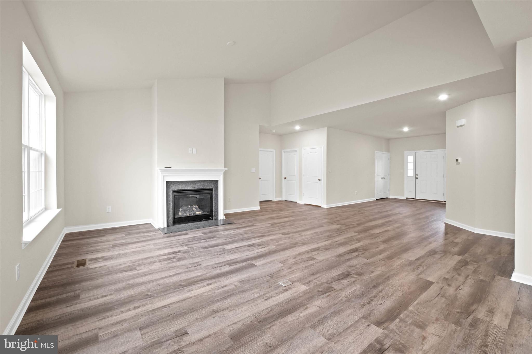 211 Laks Court, Unit JEFFERSON Smyrna, DE 19977 - Photo 16 of 22 a view of an empty room with window and fire place
