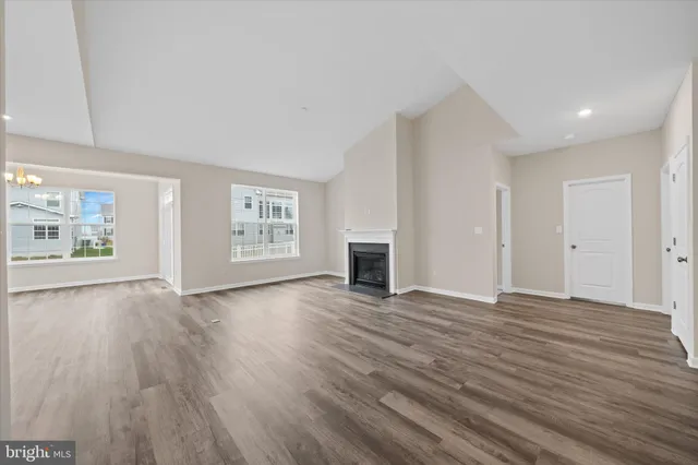 a view of an empty room with window and fire place