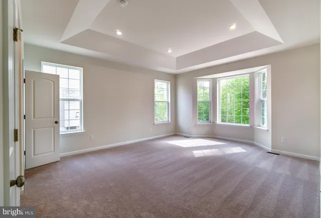 an empty room with windows lake and mountain view