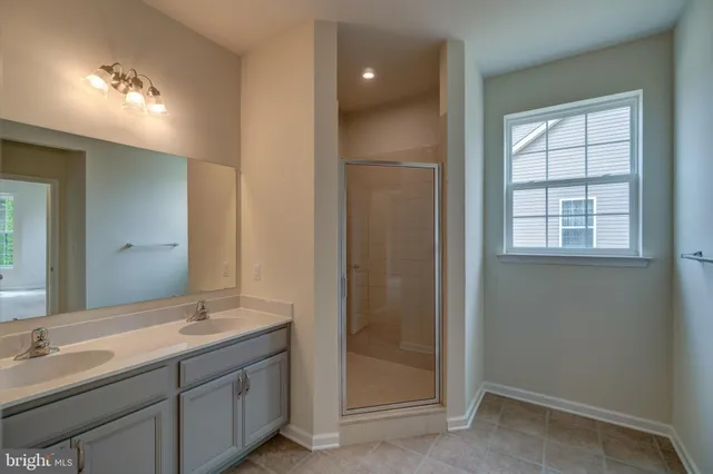 a bathroom with a double vanity sink and a mirror