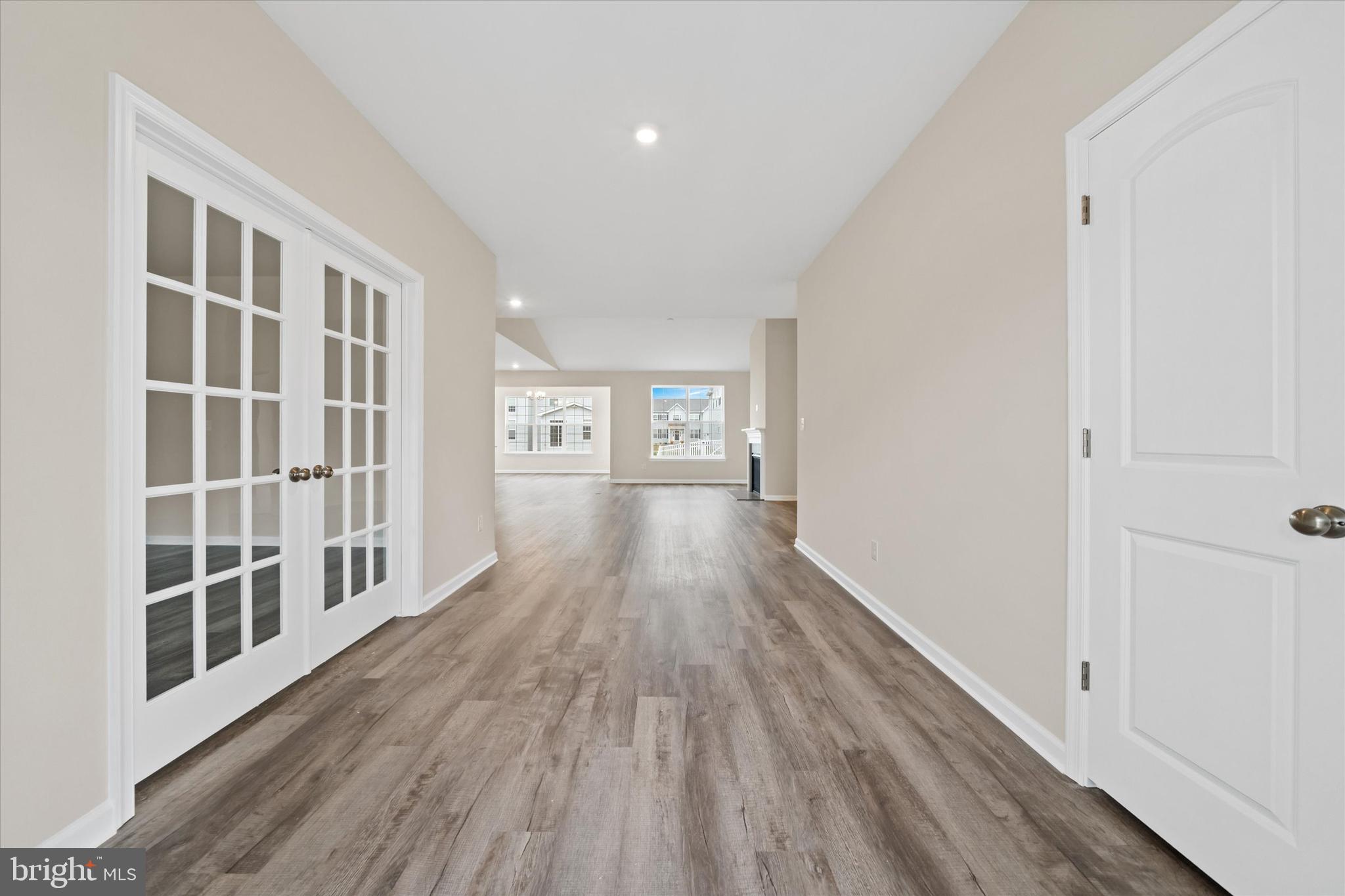 211 Laks Court, Unit JEFFERSON Smyrna, DE 19977 - Photo 4 of 22 a hallway with wooden floor and windows