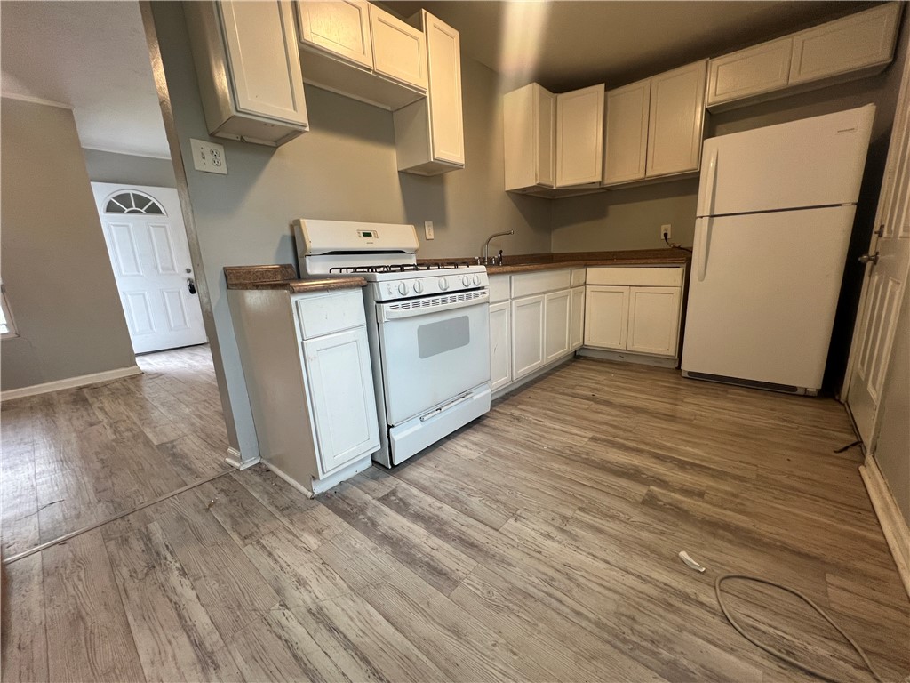5564 Hampshire Road Corpus Christi, TX 78408 - Photo 2 of 7 a kitchen with stainless steel appliances a refrigerator a sink a stove a microwave a counter top space and cabinets
