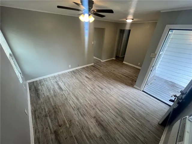 a view of hallway with stairs and wooden floor