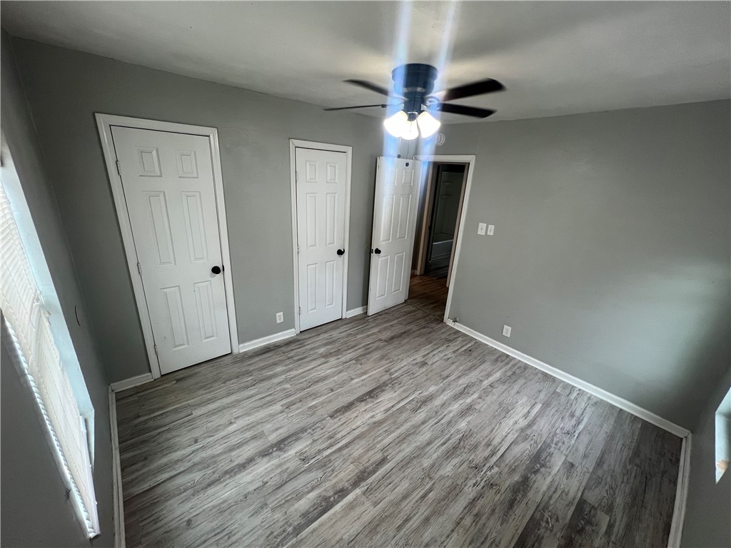 5564 Hampshire Road Corpus Christi, TX 78408 - Photo 4 of 7 an empty room with wooden floor and entryway