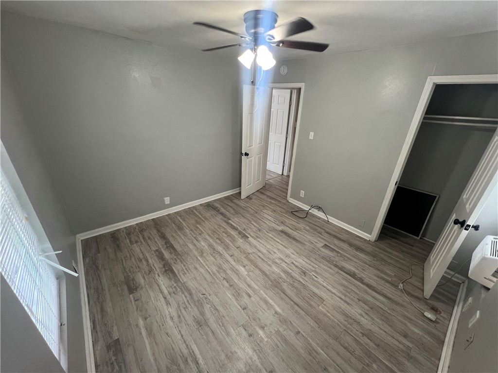 5564 Hampshire Road Corpus Christi, TX 78408 - Photo 5 of 7 a view of room with a ceiling fan and hardwood floor