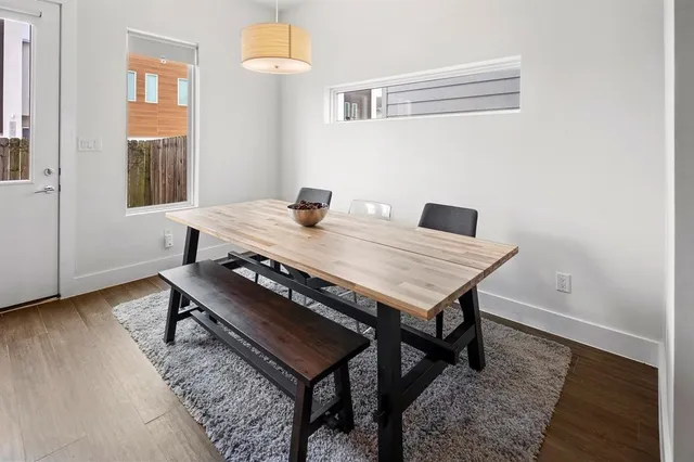 a view of a dining room with furniture and wooden floor