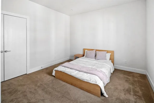 a bedroom with a bed and curtain