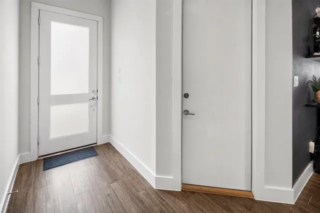 a view of a hallway with wooden floor