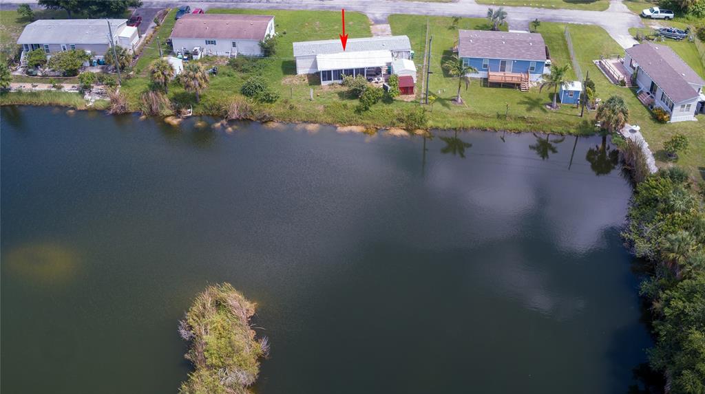 2811 Carl Avenue Punta Gorda, FL 33950 - Photo 1 of 8 an aerial view of a house with a garden and lake view
