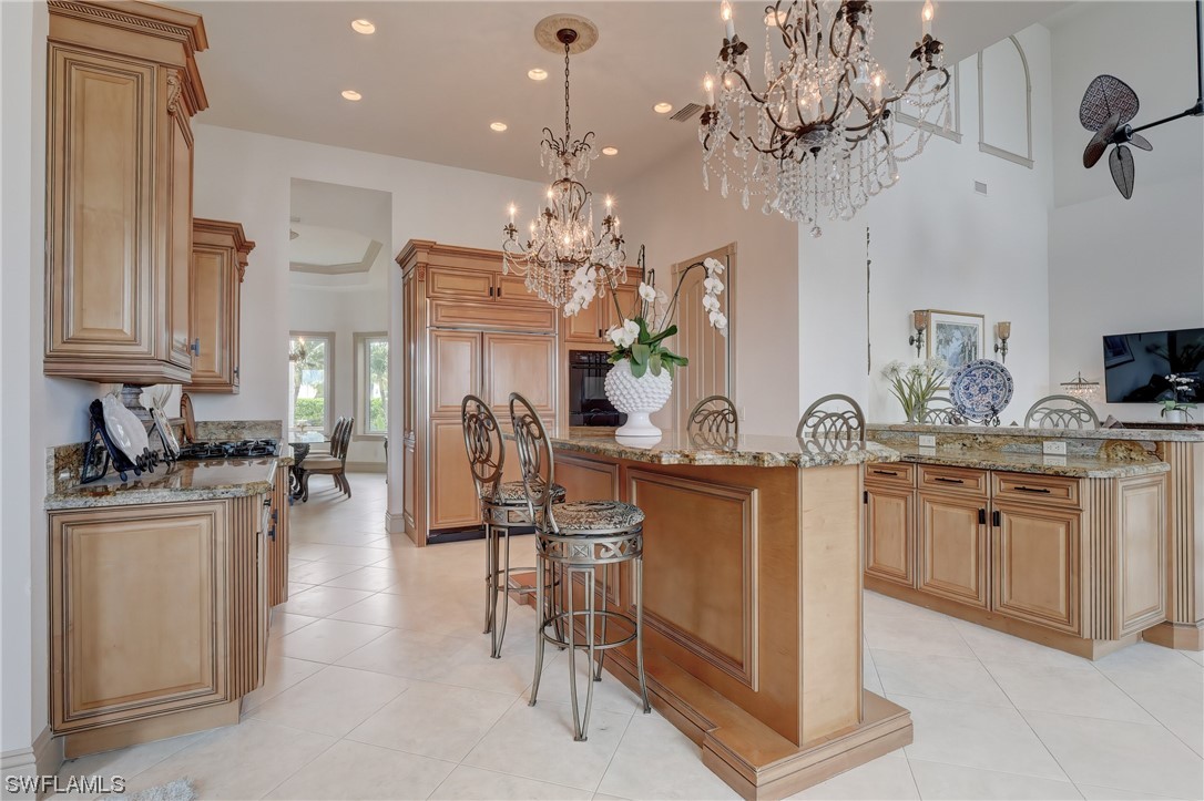 5960 Harborage Drive Fort Myers, FL 33908 - Photo 11 of 32 a kitchen with stainless steel appliances granite countertop a sink dishwasher a stove a refrigerator and a dining table with wooden floor