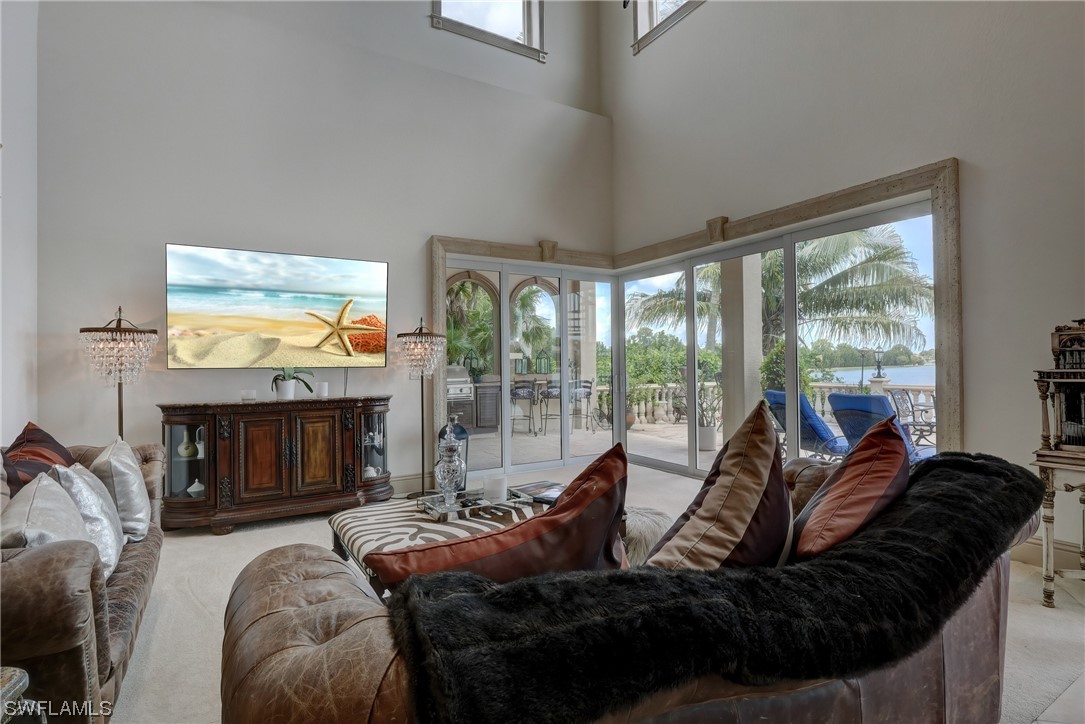 5960 Harborage Drive Fort Myers, FL 33908 - Photo 14 of 32 a living room with furniture a fireplace and floor to ceiling window