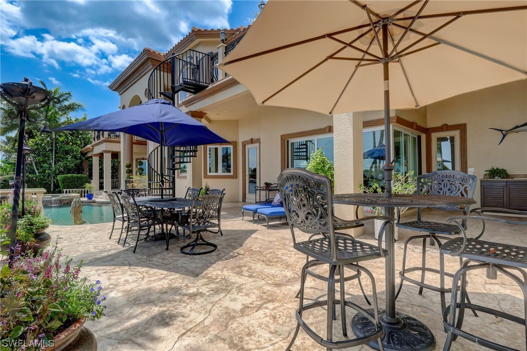 5960 Harborage Drive Fort Myers, FL 33908 - Photo 18 of 32 a view of a patio with a table and chairs under an umbrella