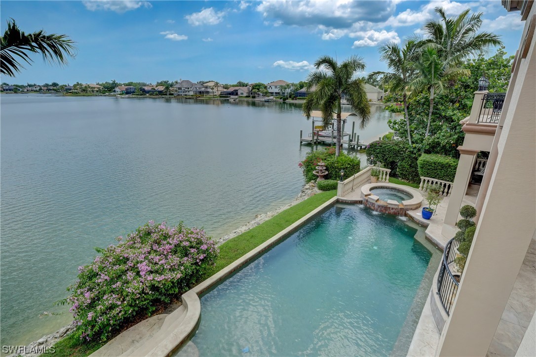 5960 Harborage Drive Fort Myers, FL 33908 - Photo 20 of 32 a view of a lake with a house in the background