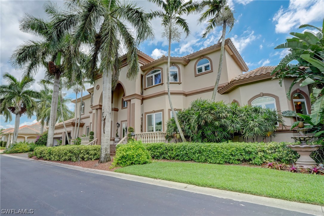 5960 Harborage Drive Fort Myers, FL 33908 - Photo 2 of 32 a view of a white house with a tree in front of it