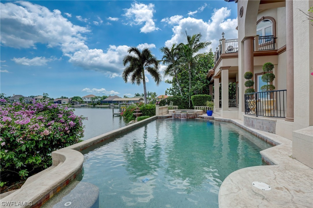 5960 Harborage Drive Fort Myers, FL 33908 - Photo 21 of 32 a view of a swimming pool with a bench in front of house