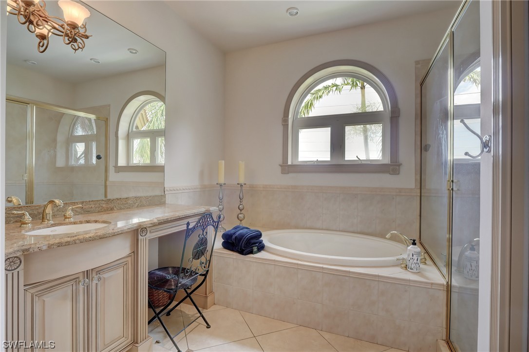 5960 Harborage Drive Fort Myers, FL 33908 - Photo 24 of 32 a spacious bathroom with a granite countertop tub a mirror and a window
