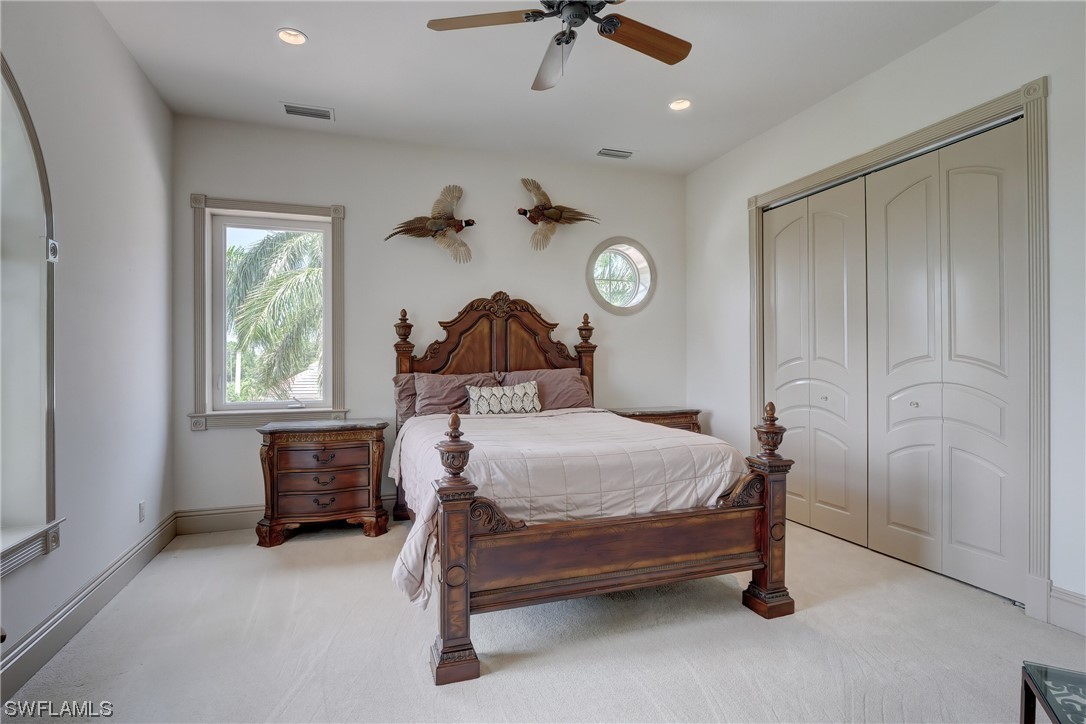 5960 Harborage Drive Fort Myers, FL 33908 - Photo 30 of 32 a bedroom with a bed and a chandelier